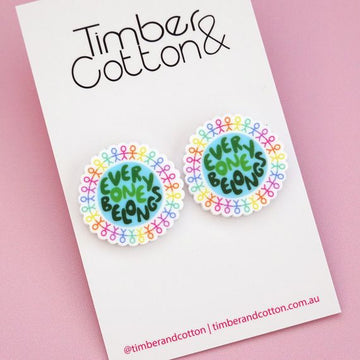 Acrylic statement stud earrings for Harmony Day featuring the words 'everyone belongs' in the shape of the world, surrounded by rainbow people.